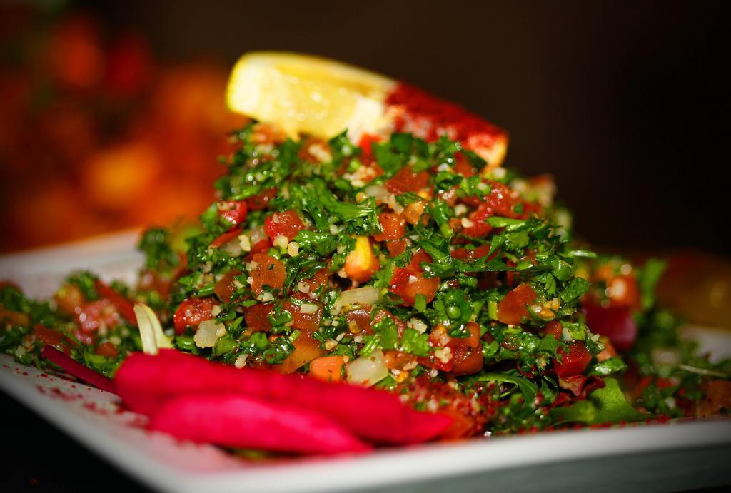 Taboulie Salad · Chopped Italian parsley mixed with bulgur, tomato, green onion, fresh mint, freshly squeezed lemon juice, and extra virgin olive oil.