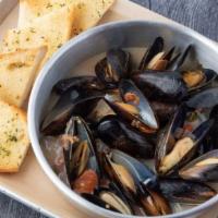 Drunken Mussels · Black Mussels in our zesty tomato basil white wine broth served with grilled garlic bread