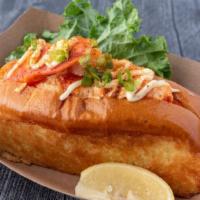 Connecticut Roll · Warm Maine lobster cooked in herb butter with a swipe of mayo topped with old bay and green ...