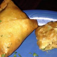 Samosa · Vegetarian. Stuffed with potatoes, cheese, peas, and a special blend of herbs and spices. Se...