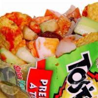 Tostilocos · TOSTITO CHIPS, PORK RINDS, CUCMBER, JICAMA, PEANUTS, CHAKA CHAKA, CHAMOY, HOT SAUCE