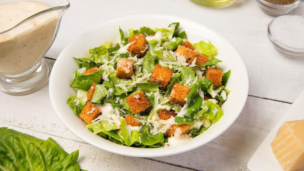 Caesar Salad · Crisp romaine tossed with croutons, Caesar dressing, and grated cheese.