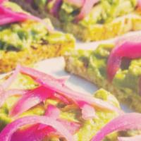 Avocado Toast · Sourdough toast topped with avocado, pickled onions and micro greens.