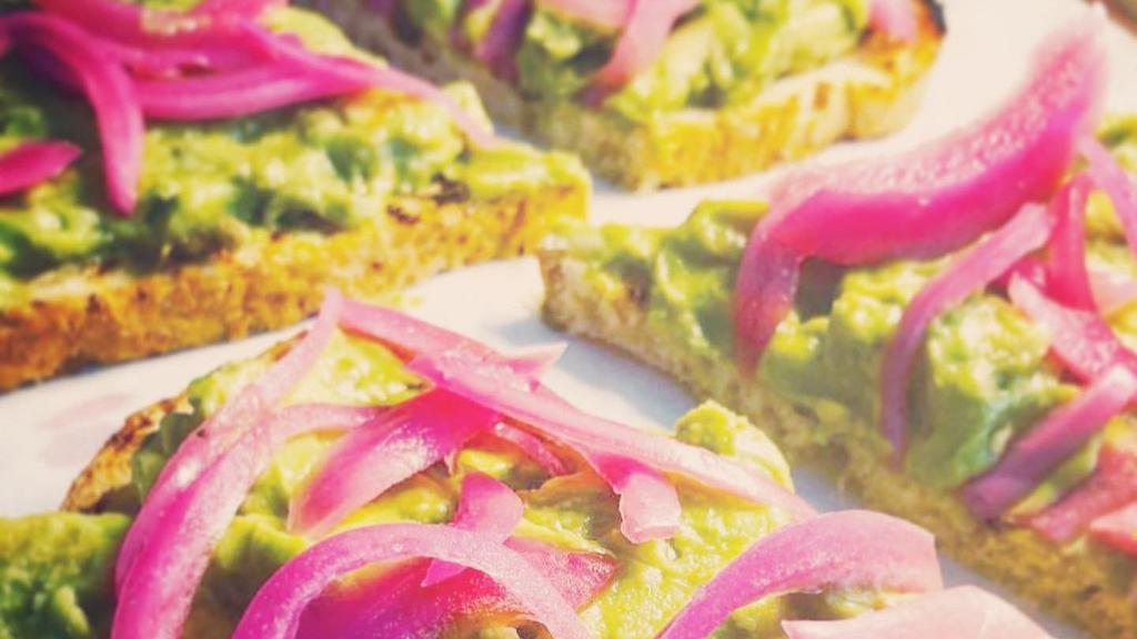 Avocado Toast · Sourdough toast topped with avocado, pickled onions and micro greens.