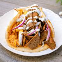 Cali Pita · hand-carved gyros or grilled chicken, fire feta, onions, tzatziki and french fries on warm p...