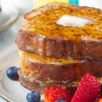 Crispy French Toast · Three crispy slices of thick, egg-washed brioche bread topped served with syrup and powdered...