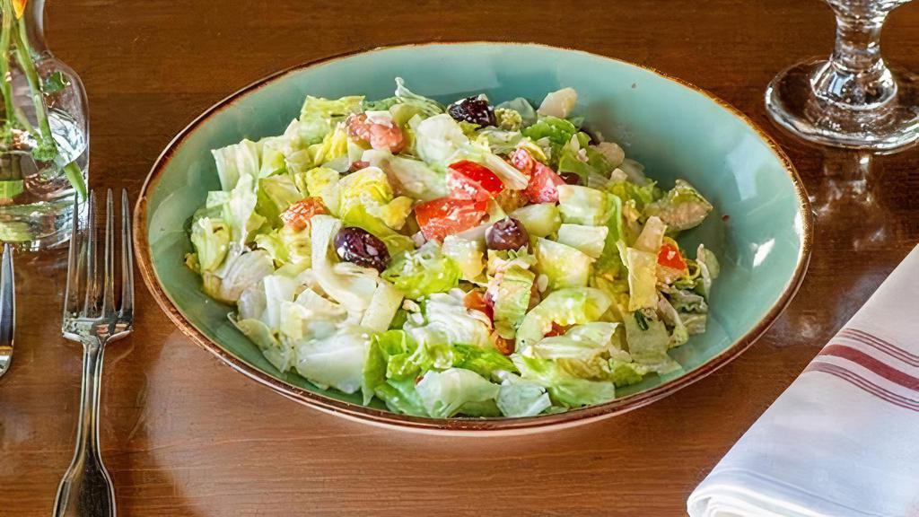 Mediterranean Salad · Romaine lettuce, tomatoes, cucumber, Kalamata olives, and feta cheese in a vinaigrette dressing.