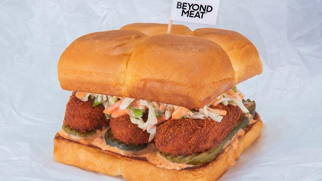 Beyond The Hot Chick · Three crispy fried Beyond® tenders, served Nashville Hot with secret sauce, dill pickle slices and slaw; served on King's Hawaiian rolls, plant-based/vegetarian protein