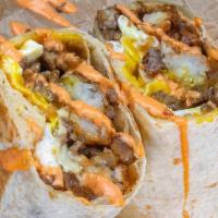 Impossible Haus Burrito · 3 sunny side up eggs, Impossible sausage patty, white american cheese, caramelized onions, c...