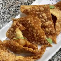 10 Pieces Fried Wontons · Deep fried wonton skin with chicken served with sweet and sour sauce.