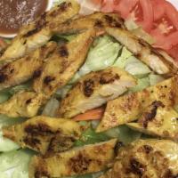 Chicken Satay Salad · Thai style marinated chicken topped with romaine, cucumber, carrot and tomatoes with peanut ...