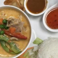 Panang Curry · Simmered panang chill paste in coconut milk with peas and carrots and bell peppers. Spicy.