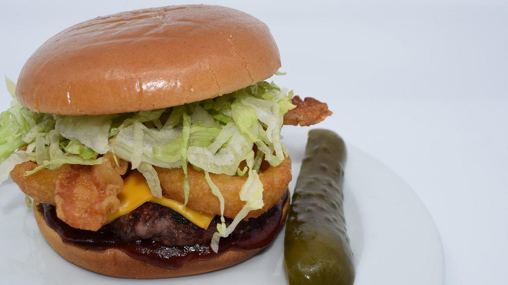 The Saloon Burger · Bacon, Golden Brown Onion Ring, Sweet Baby Ray’s, BBQ Sauce, Shredded Lettuce, and Melted Cheddar Cheese.

100% Fresh Ground in House, 1/2 lb, All Natural Chuck, Flame Grilled, and served on a toasted bun with a dill pickle spear on the side.