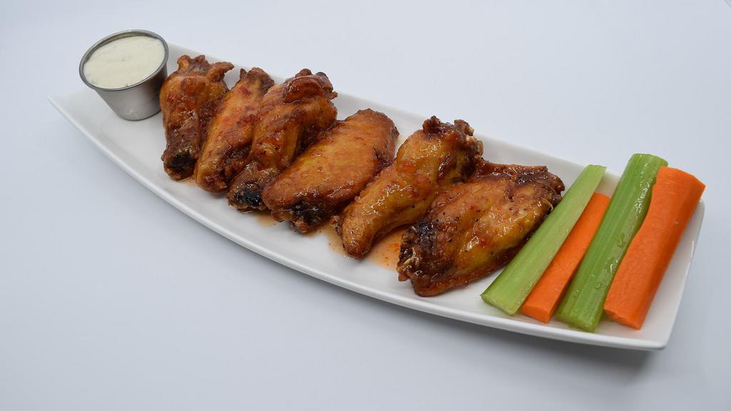 Jumbo Asian Sweet Chili Wings · Large wings marinated overnight in a rub, slow cooked, deep fried and tossed in Asian Sweet Chili sauce. Served with crisp celery, and carrot sticks.
