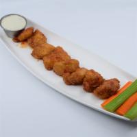 Boneless Asian Sweet Chili Wings · Boneless wings deep fried and tossed in Asian Sweet Chili sauce. Served with crisp celery, a...