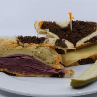The Reuben Sandwich · Toasted rye bread, thinly sliced corned beef, Swiss cheese, sauerkraut, Russian Dressing wit...