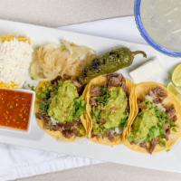 Tacos Norteños (3) · Carne asada tacos, topped with cilantro, onions and guacamole. Served with queso fresco & ch...