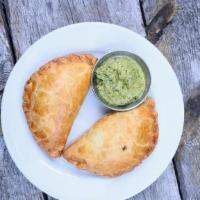 Veggie Empanada (V) · Yummy blend of spinach, roasted corn, bell peppers, potato, cilantro, onions and pepper-jack...