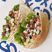 Beef Kabob Pita · Marinated beef with lettuce, tomatoes, cucumber, onions, and your choice of sauce wrapped in...