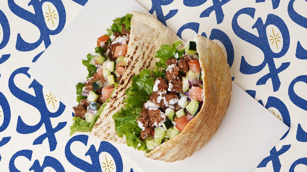 Beef Kabob Pita · Marinated beef with lettuce, tomatoes, cucumber, onions, and your choice of sauce wrapped in a pita
