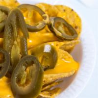 Nachos · classic corn tortilla chips with options of melted, yellow, creamy cheese, and/or savory jal...