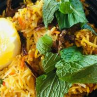 Chicken Biryani · Chicken slow cooked in basmati rice with spices and veggies.