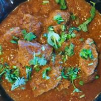 Lamb Curry · Rich chunks of lamb slow cooked with a yogurt curry sauce.