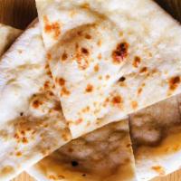Butter Naan · Oven baked soft bread with butter spread.