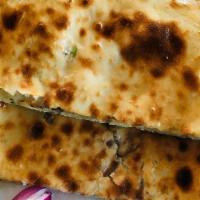Onion Naan · Oven baked soft bread with onion spread.