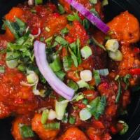 Gobi Manchurian · Fried cauliflower florets sautéed with onions, bell peppers, spring onions, garlic in soy an...