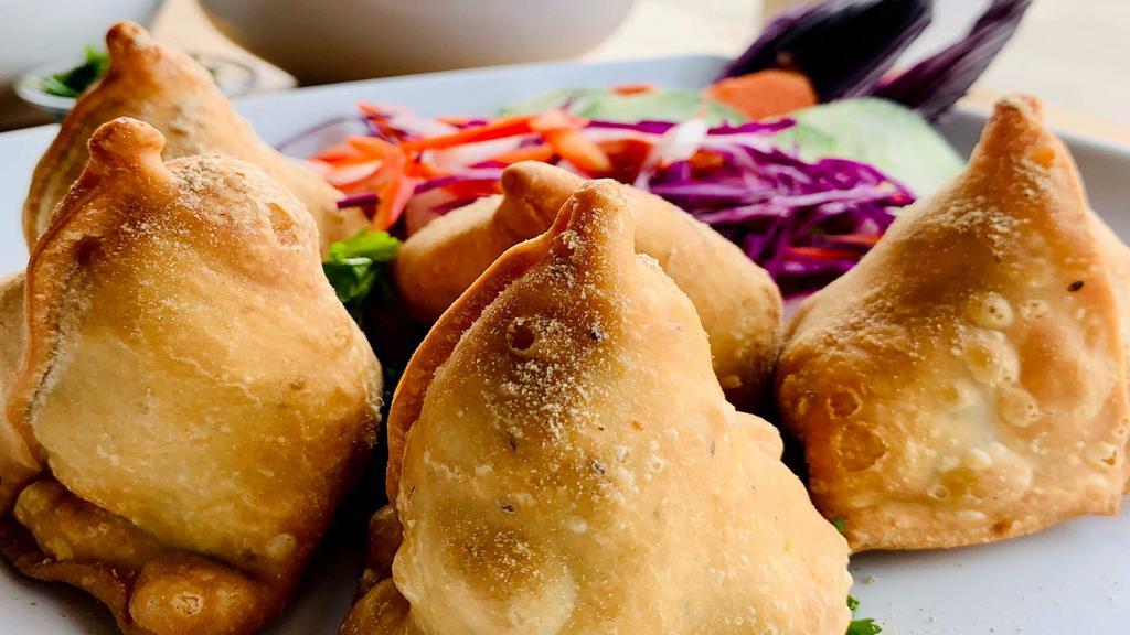 Veg Samosa · Veg Samosa is golden and crispy on the outside and has a tasty blend of potatoes, green peas, and seasoned with Indian spices and herbs. (2 pieces per order)