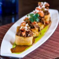 Sopes · Golden crispy corn masa boats with braised short rib, aged cotija cheese, open fire roasted ...