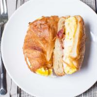 French Breakfast · Two scrambled eggs and American cheese with a bacon on a croissant.