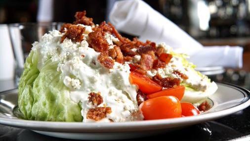 The Wedge · Iceberg Lettuce, Blue Cheese Crumbles, Double-Smoked Bacon, Tomatoes, House made Blue Cheese Dressing