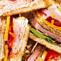 Club Sandwich · Mayonnaise, lettuce, tomatoes, ham, bacon, swiss and turkey on sourdough.