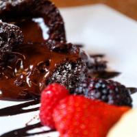 Chocolate Lava Cake  · Molten center chocolate cake with berries and housemade ice cream.