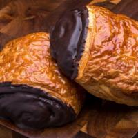 Chocolate Croissant · Traditional croissant made with European style butter filled with and dipped in dark chocola...