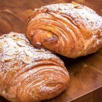 Almond Croissant · Traditional croissant made with European style butter filled with almond cream and topped wi...