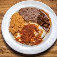 Huevos Rancheros · Corn tortillas layered with two eggs refried beans, spicy sauce topped with jack cheese.