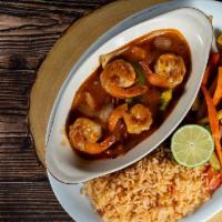Camarones Rancheros · Whole shrimp sautéed in ranchero sauce with bell peppers and onions. Served with rice and sa...