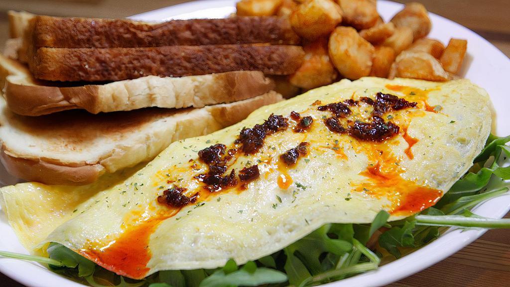 Arugula Ham & Cheese Omelette · Arugula, ham, and cheese with chili oil drizzle. Served with choice of side and choice of toast.