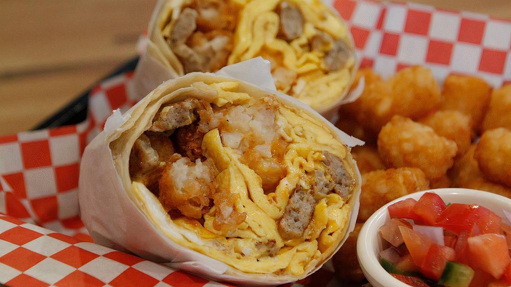 Breakfast Burrito · Choice of meat, cheese, eggs, tater tots, smoked cheese sauce, and pico De gallo. Choice of side.