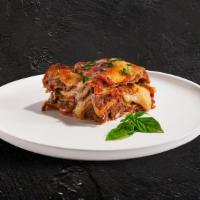 Meet The Meat (Lasagna) · Layers of pasta, ricotta, mozzarella, ground beef, and tomato sauce baked in an oven and top...