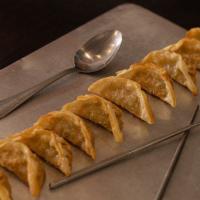 Pot Stickers (10) · Pan fried chicken dumplings filled with green onions.