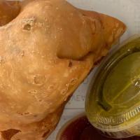 Vegetable Samosa · Fried pastry with savory vegetable filling.