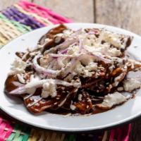 Green Chilaquiles And Eggs · Hot & Tasty breakfast dish prepared with two farm fresh, served over tortilla chips tossed i...
