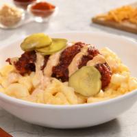 Nashville Chicken · Nashville Hot chicken tender served over mac-n-cheese, drizzled with comeback sauce and topp...