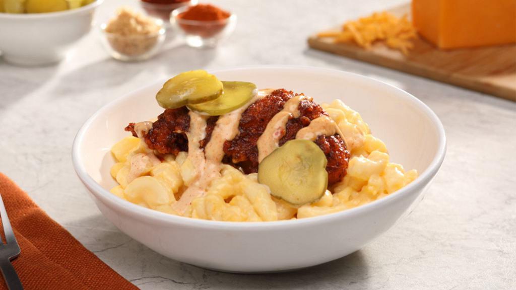 Nashville Chicken · Nashville Hot chicken tender served over mac-n-cheese, drizzled with comeback sauce and topped with dill pickle slices.