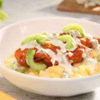 Buffalo Chicken · Buffalo chicken tenders served over mac-n-cheese and topped with blue cheese crumbles and ce...
