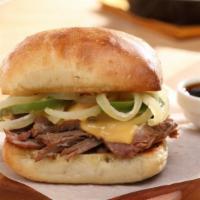 Philly Cheese Braised Beef Sandwich · Braised beef on a Ciabatta bun with American cheese, grilled green pepper & onion strips, se...